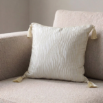 Coussin carré crème à motif ondulé avec pompons